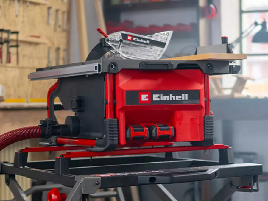 Акумуляторна настільна пилка Einhell TE-TS 36/8 T Li-Solo використовується в майстерні; дерев'яна дошка розпилюється.